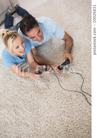 Couple playing video games on area rug Couple playing video games on area rug 10026831