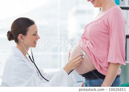 Female doctor examining pregnant woman 10026851