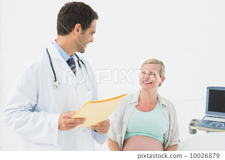 Smiling pregnant woman having a check up with doctor Smiling pregnant woman having a check up with doctor 10026879