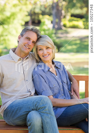 Smiling couple sitting on park Smiling couple sitting on park 10027348