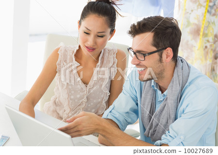 Fashion designers using laptop in studio Fashion designers using laptop in studio 10027689