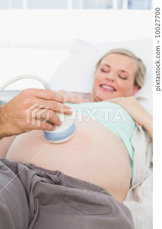 Pregnant woman having an ultrasound scan Pregnant woman having an ultrasound scan 10027700