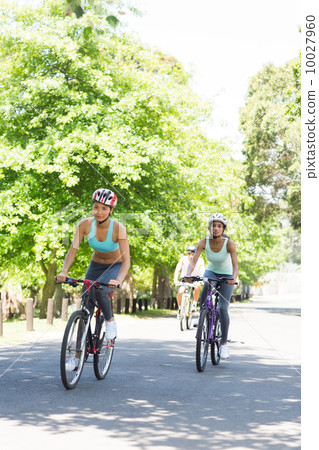 Sporty women riding bicycles 10027960