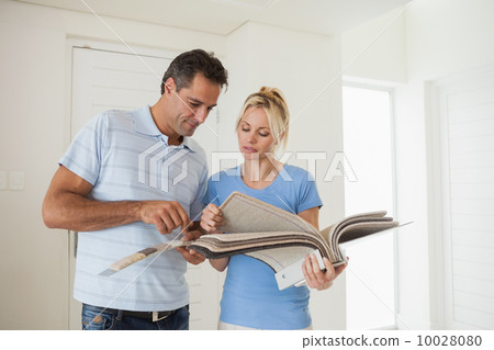 Couple looking at color book in house Couple looking at color book in house 10028080