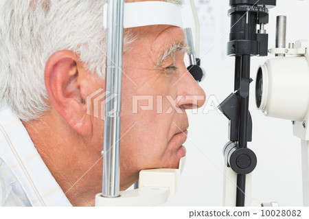Senior man getting his cornea checked Senior man getting his cornea checked 10028082