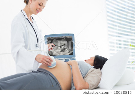 Doctor doing ultrasound pregnant woman 10028815
