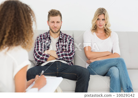 Unhappy couple not talking on the couch Unhappy couple not talking on the couch 10029142