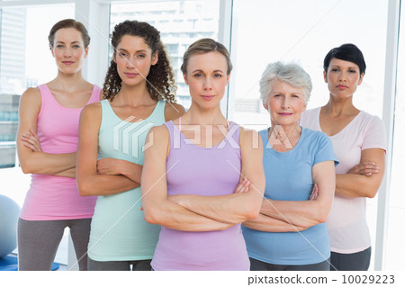 Confident women with arms crossed in yoga class Confident women with arms crossed in yoga class 10029223