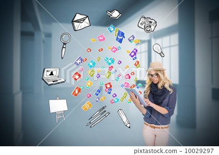 Stylish blonde using tablet pc with app icons 10029297
