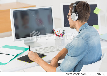 Casual male photo editor using graphics tablet 10029612