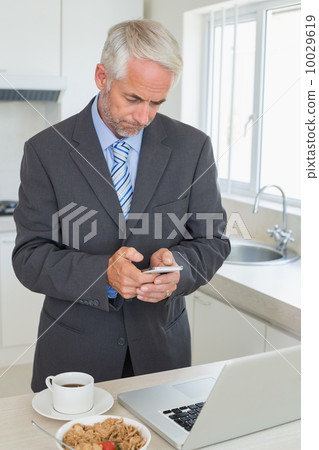 Businessman texting in the morning before work Businessman texting in the morning before work 10029619