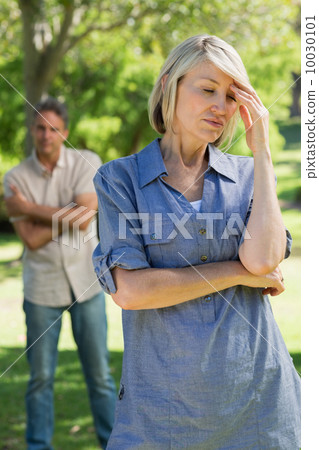 Sad couple in parkland Sad couple in parkland 10030101