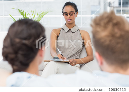 Therapist talking with couple on the couch 10030213