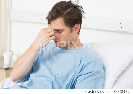 Patient suffering from headache relaxing in hospital 10030422