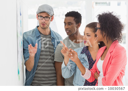 Artists in discussion in front of whiteboard 10030567