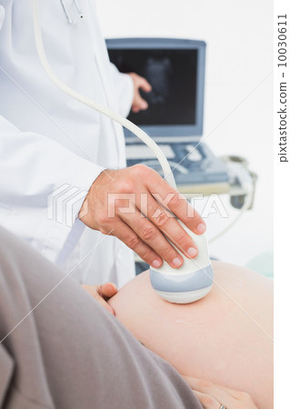 Pregnant woman having a sonagram scan Pregnant woman having a sonagram scan 10030611