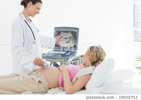 Doctor performing ultrasound 10030752