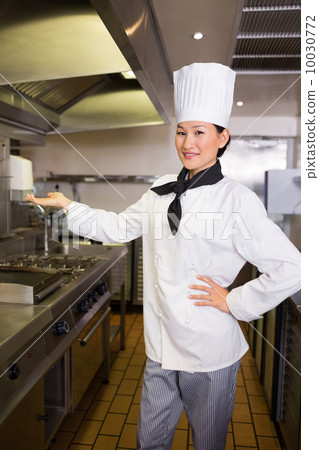 Confident female cook in kitchen Confident female cook in kitchen 10030772