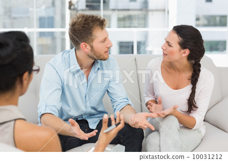 Unhappy couple arguing at therapy session Unhappy couple arguing at therapy session 10031212