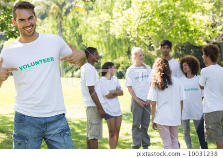 Handsome volunteer pointing at tshirt 10031238