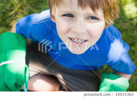 Young boy in gardening gloves at park 10031363