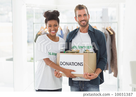 Smiling young couple with clothes donation Smiling young couple with clothes donation 10031387