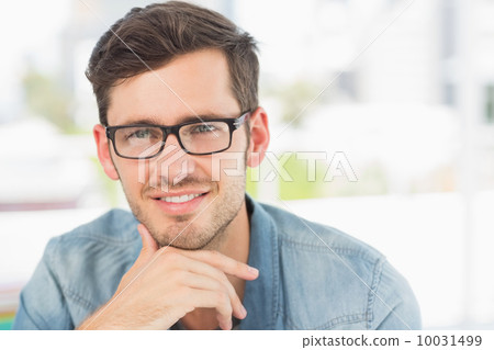 Casual male photo editor at a bright office Casual male photo editor at a bright office 10031499