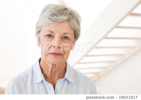 Retired woman frowning at the camera Retired woman frowning at the camera 10031917