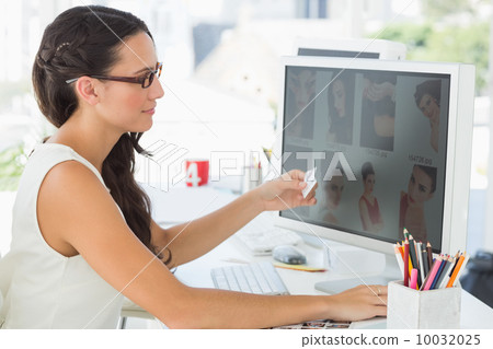 Pretty young editor working at her desk 10032025