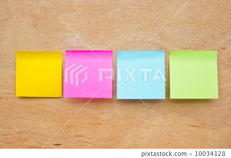 Four colorful sticky notes on wooden board. Four colorful sticky notes on wooden board. 10034128