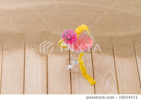 Fresh pink cocktail at the beach Fresh pink cocktail at the beach 10034551