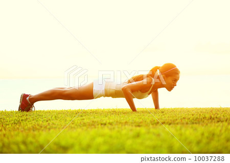 push ups or press ups exercise by young woman 10037288