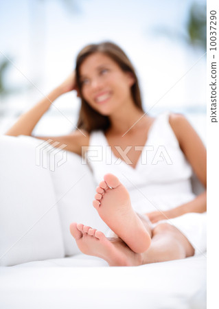 Woman feet - barefoot woman relaxing in sofa 10037290