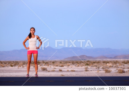 Athlete runner woman resting on road after running Athlete runner woman resting on road after running 10037301