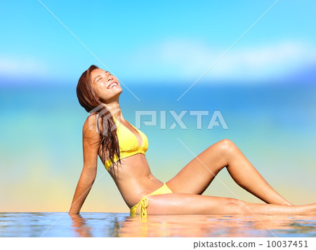 Sunbathing woman relaxing under sun in luxury spa Sunbathing woman relaxing under sun in luxury spa 10037451