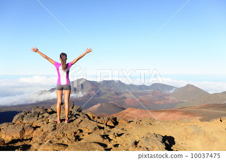 Hiking woman on top happy and celebrating success 10037475