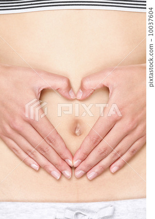 Hands forming heart on stomach 10037604