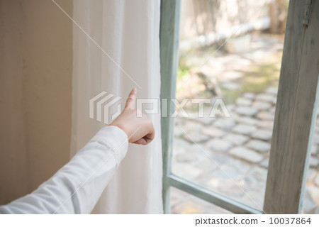 A woman pointing outside 10037864