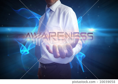 Businessman presenting the word awareness 10039058