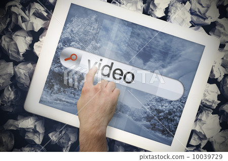 Hand touching video on search bar on tablet screen Hand touching video on search bar on tablet screen 10039729
