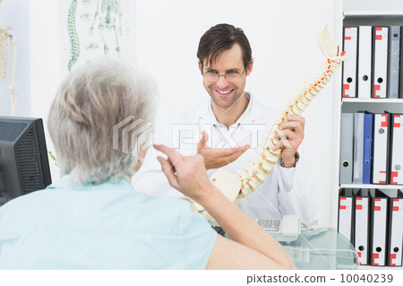 Friendly doctor explaining spine to a senior patient 10040239