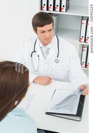 Doctor in conversation with female patient in medical office 10040324