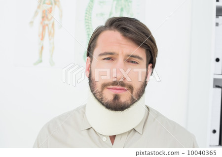 Portrait of a young man suffering from neck pain Portrait of a young man suffering from neck pain 10040365