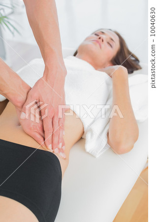 Close-up of a physiotherapist massaging woman's body Close-up of a physiotherapist massaging woman's body 10040630