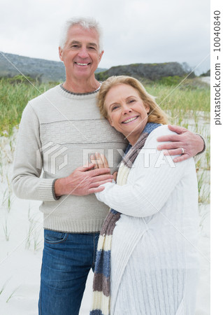 Happy senior man embracing woman at beach Happy senior man embracing woman at beach 10040840