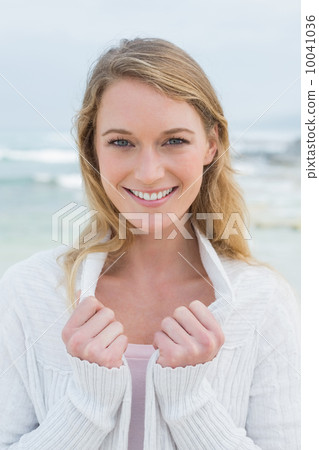 Close-up portrait of a smiling casual woman at beach 10041036