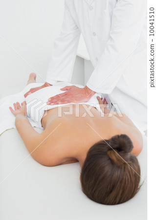 Male physiotherapist massaging woman's back Male physiotherapist massaging woman's back 10041510