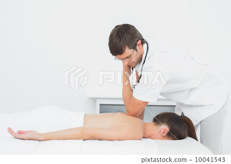 Male physiotherapist massaging woman's back Male physiotherapist massaging woman's back 10041543