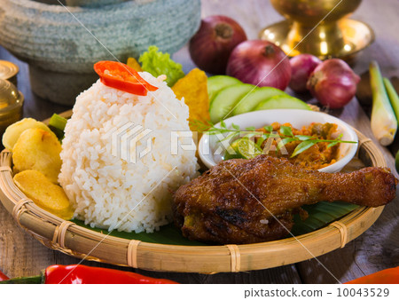 indonesian fried chicken rice on traditional background 10043529