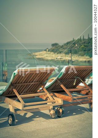 Hotel Poolside Chairs with Sea view. 10044327